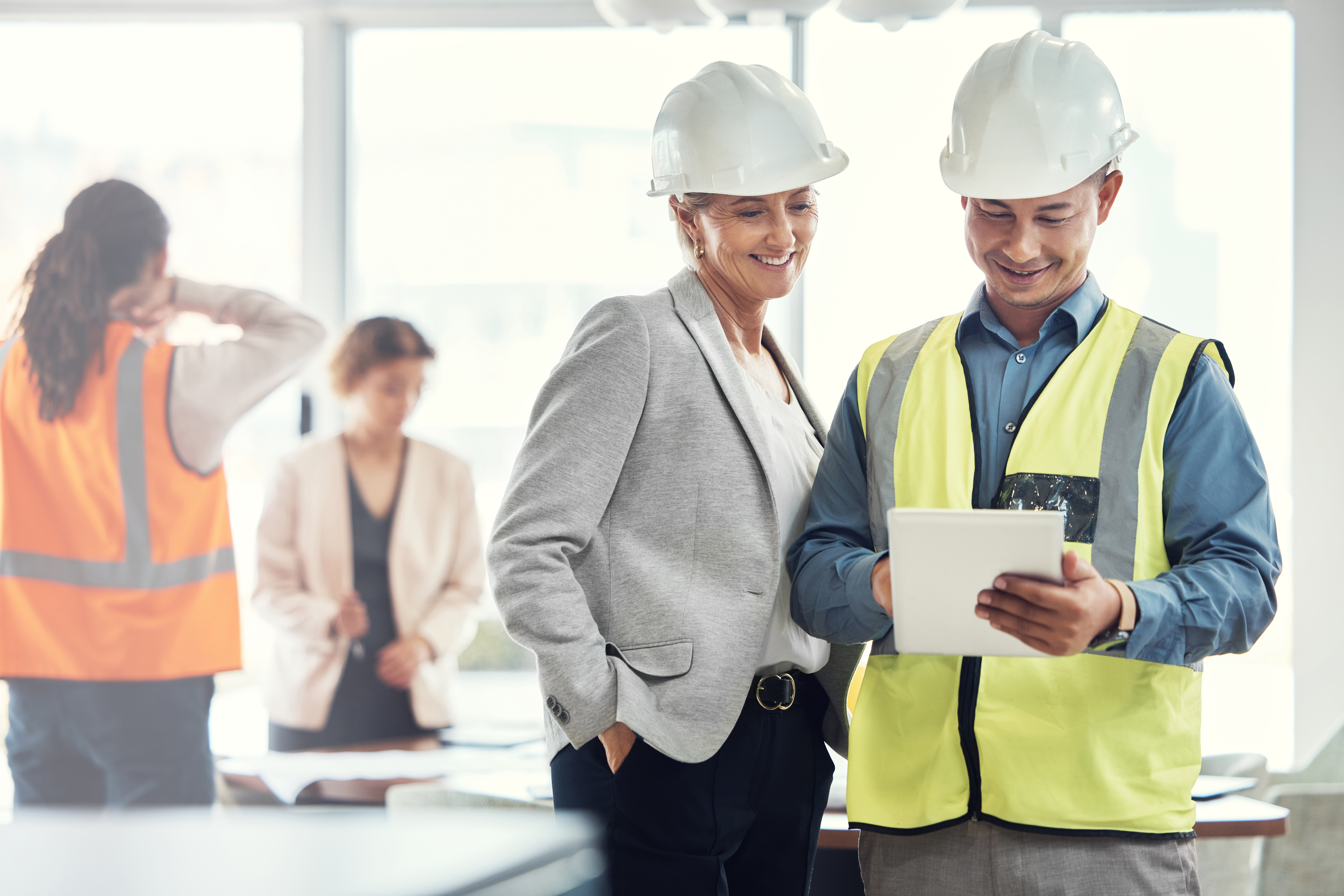 Man, woman and tablet in office for architecture analysis, construction teamwork or vision. Architect team, contractor or reading for property development, real estate or building project on app ux.